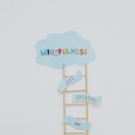 Minimalist artwork depicting mindfulness concept with a ladder and cloud on a white background.
